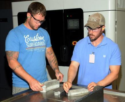 Patternmaker Caleb Guelich, left, and Engineer Justin Reynolds, both of Fleet Readiness Center East, inspect polymer form blocks made through 3D printing.   (U.S. Navy photo by Dave Marriott/released)