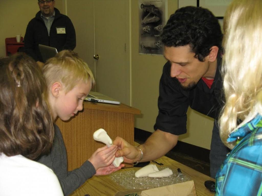 Noto using 3D printed crocodilian bones during an education outreach event. The model in my hand is the fossil crocodile's arm bone, shrunk to 50% of its actual size. 