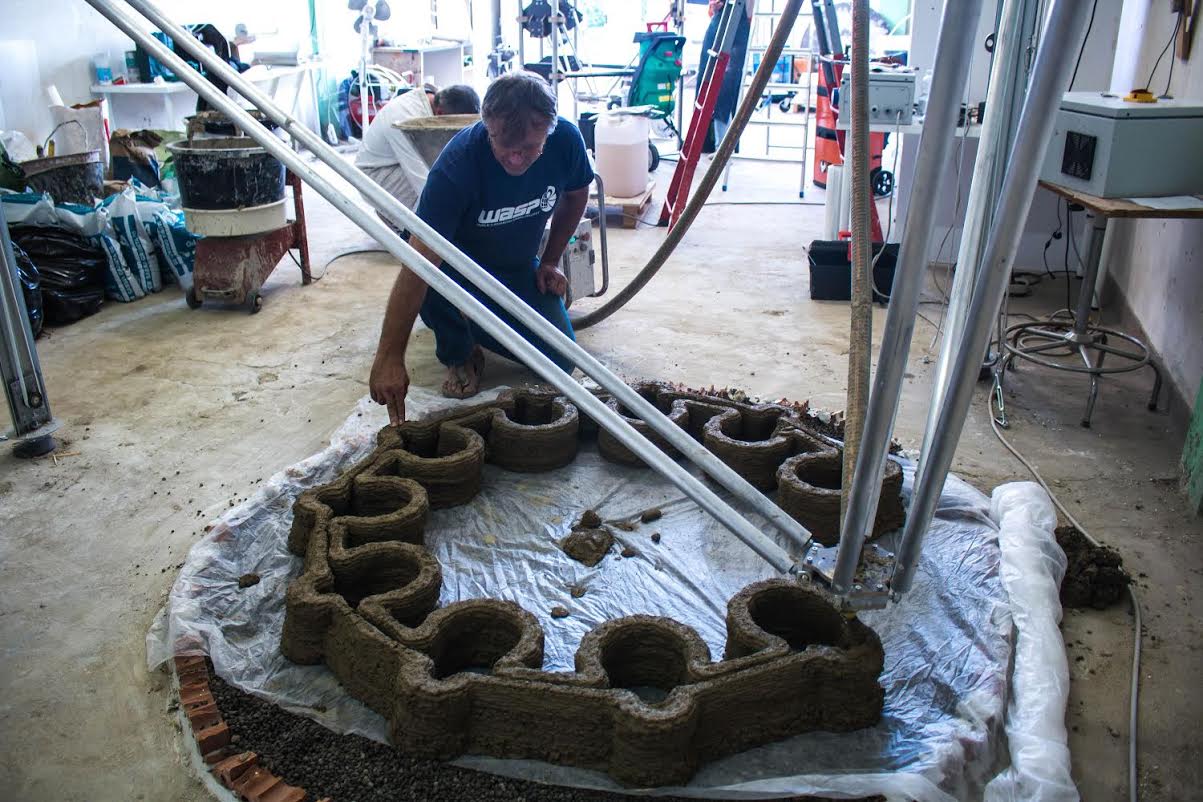 One of WASP's Big Delta 3D printers printing a large clay structure.