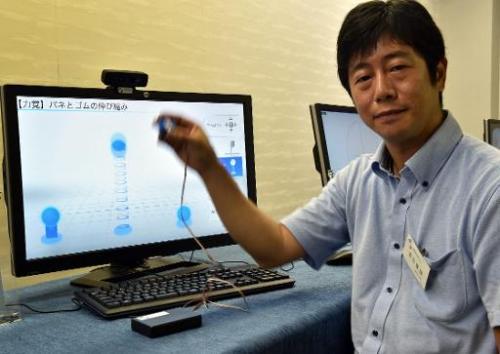 Japan's high-tech venture Miraisens CEO Natsuo Koda demonstrates "3D-Haptics Technology" at a press preview. Read more at: https://phys.org/news/2014-09-japan-firm-showcases-touchable-3d.html#jCp