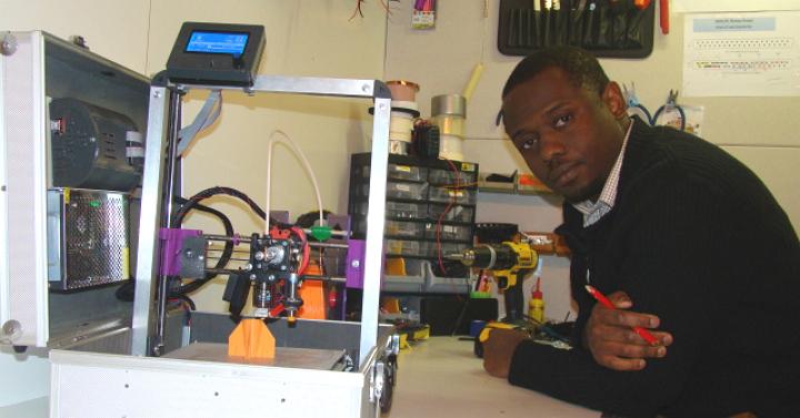 Emmanuel Adetutu with his TeeBot 3D Printer in a suitcase.