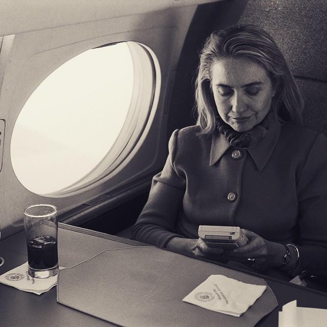 Hillary Rodham Clinton playing a Nintendo Game Boy on the flight from Austin en route to Washington in 1993.