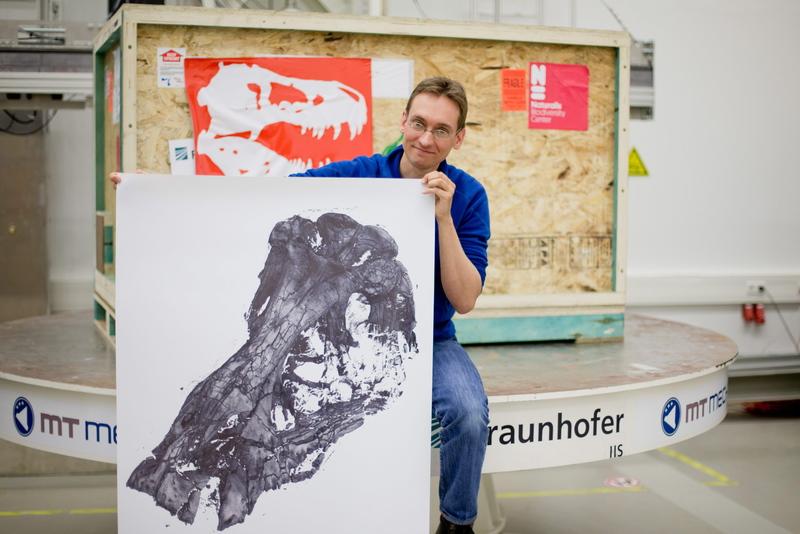 Dutch paleontologist Anne Schulp holds a print of a CT scan of a t-rex skull at the Fraunhofer-Institut in Fuerth, Germany. EPA/DANIEL KARMANN