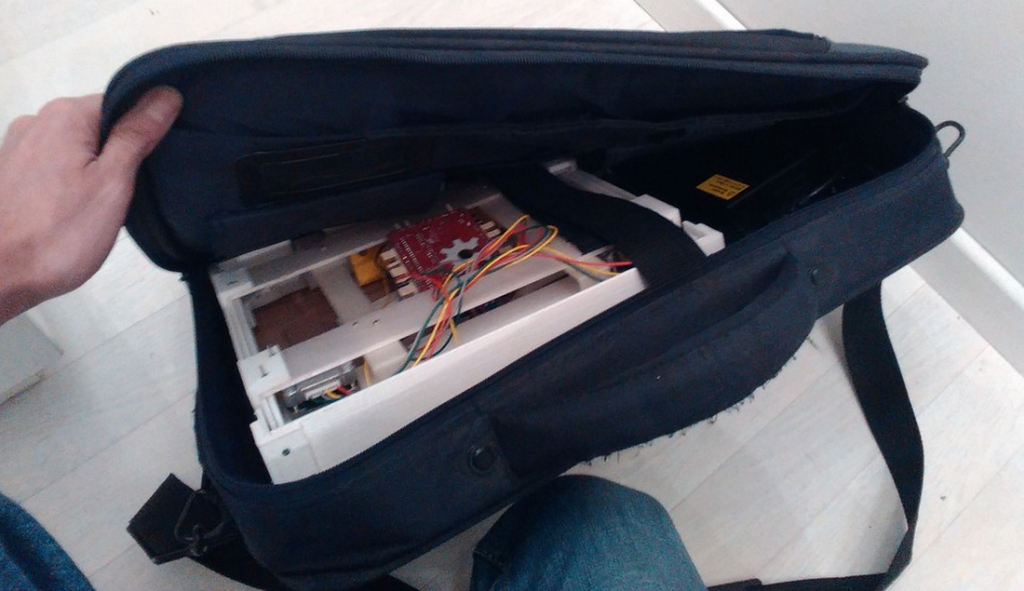 An early prototype Foldie 3D and power supply tucked into a 19 inch laptop bag.