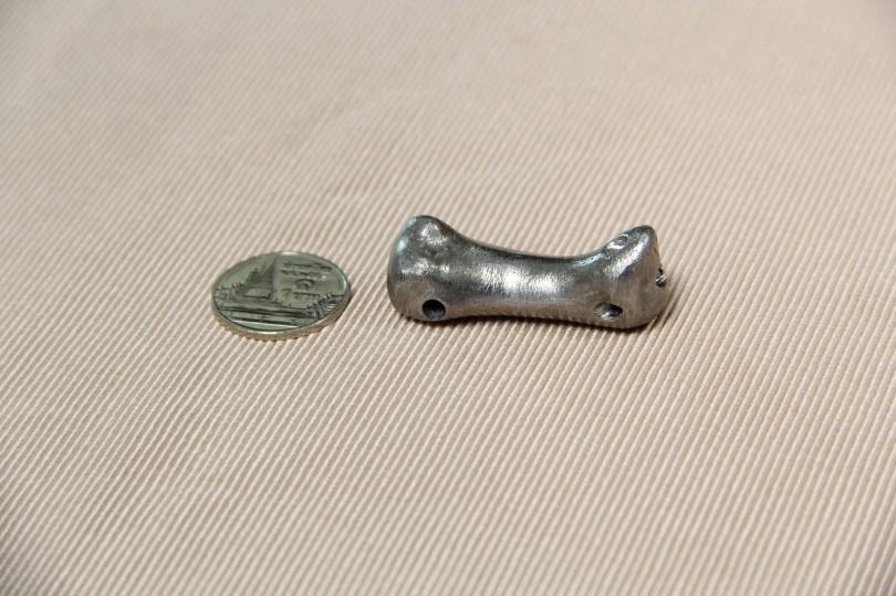 The implant beside a coin.