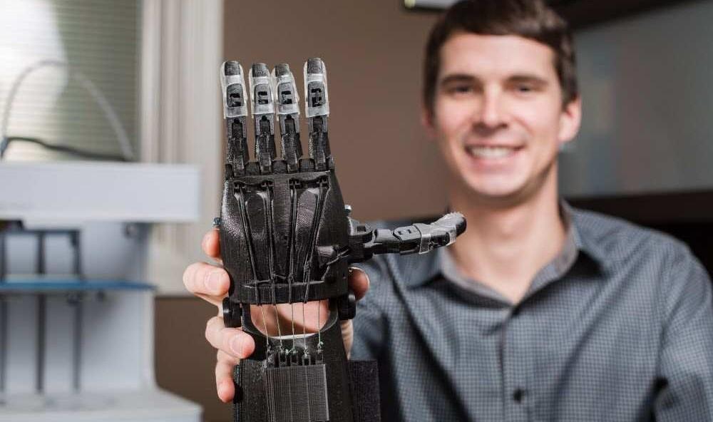 Pischke and a 3D printed e-NABLE hand.
