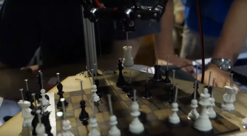 The chess robot placing a rook during a game. 