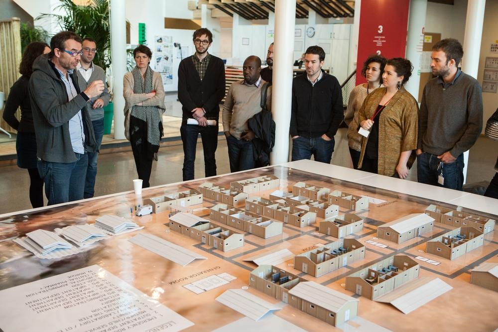 The MSF staff viewing the 3D printed hospital model. 