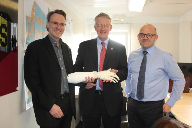 Martin Levesley and Dr. Andrew Jackson present the ALAN arm to Hilary Benn at the New UTC Leeds Construction Site