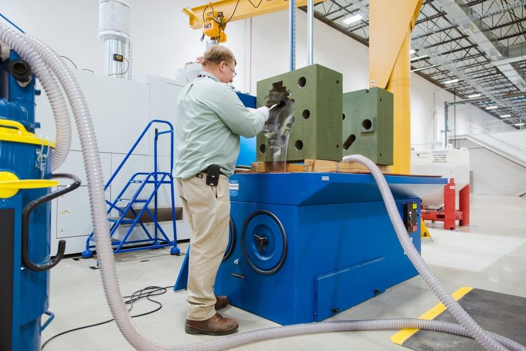 “We are building the Jell-O mold for the jelly,” says Dave Miller, the engineer working with the sand binder jetting machine (Photo: GE Reports)