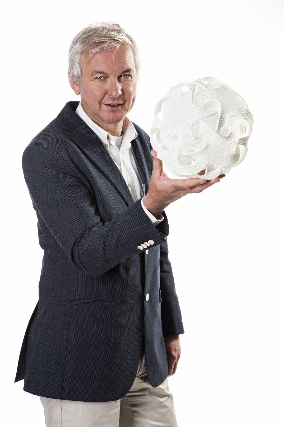 Materialise CEO Wilfried Vancraen holding 3D printed part.