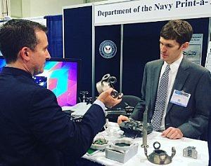 Navy engineer Steve Price talks to attendee about the small additively manufactured modular payload multi-rotor at the 2016 Sea-Air-Space Expo