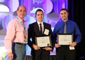 University of Massachusetts Lowell students Tito Arana, Jordan Castillo accept 2016’s Direct Digital Manufacturing Design Competition award.