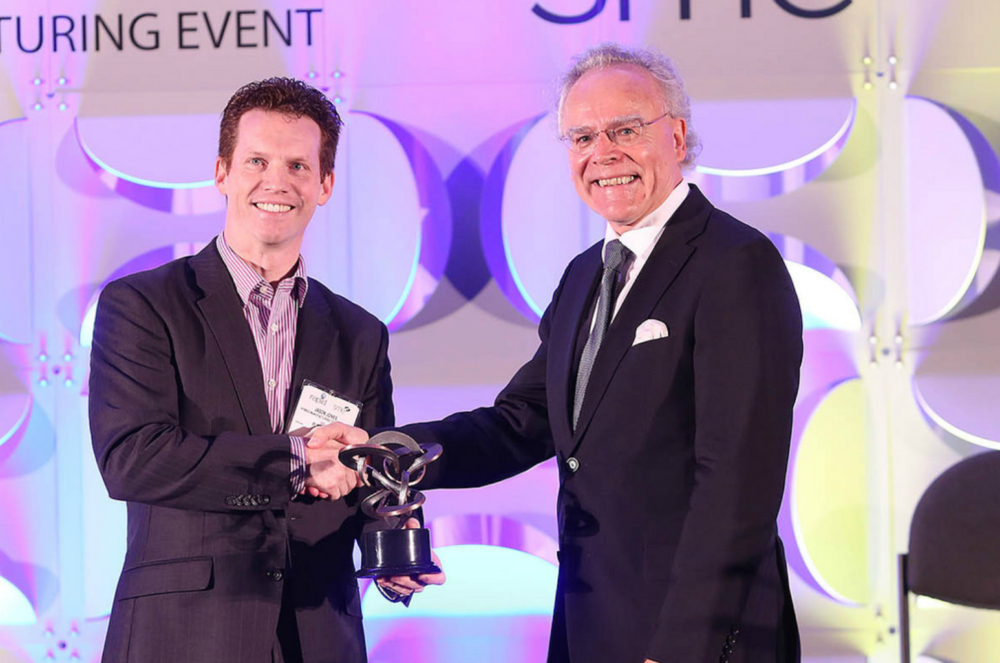 EOS founder and CEO Hans Langer accepts the SME Additive Manufacturing Industry Achievement Award.