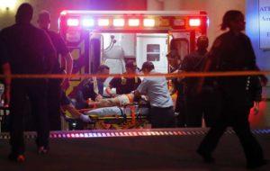 An un-named victim of the Dallas shootings is treated on the scene by paramedics. 
