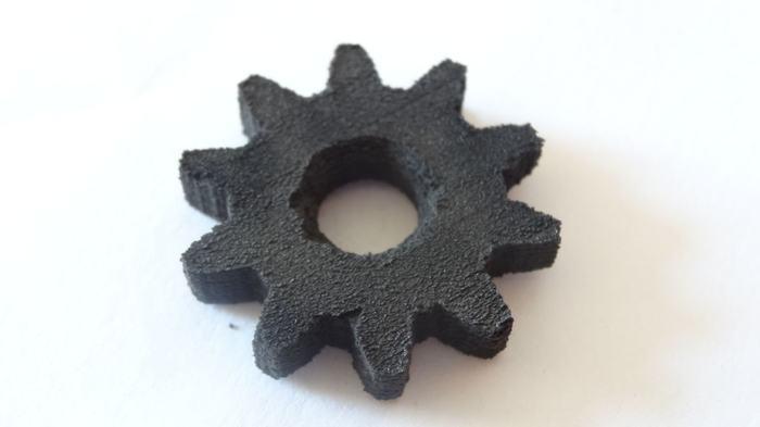The first test print made with the DIY SLS 3D printer. The gear is printed in black powder coating material at 60mm/s. It has a size of 3x3x0.5cm and took one hour to print.