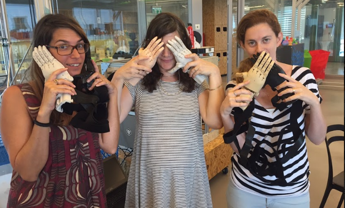 Autodesk volunteers take a break, showing off just several of what ended up being 750 3D printed prosthetic hands.