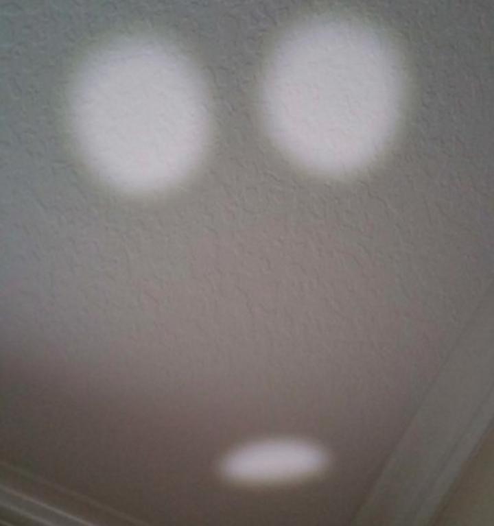 The shadow from the lamp has a secret face hidden in it. 