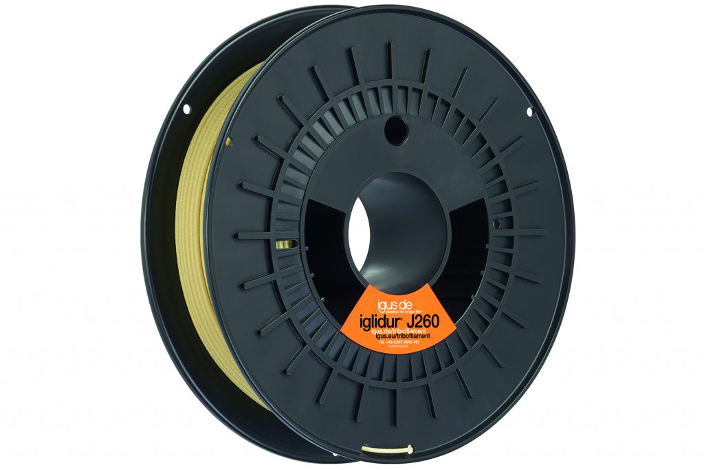 Igus Filament roll black with yellow filament for 3D printing on it