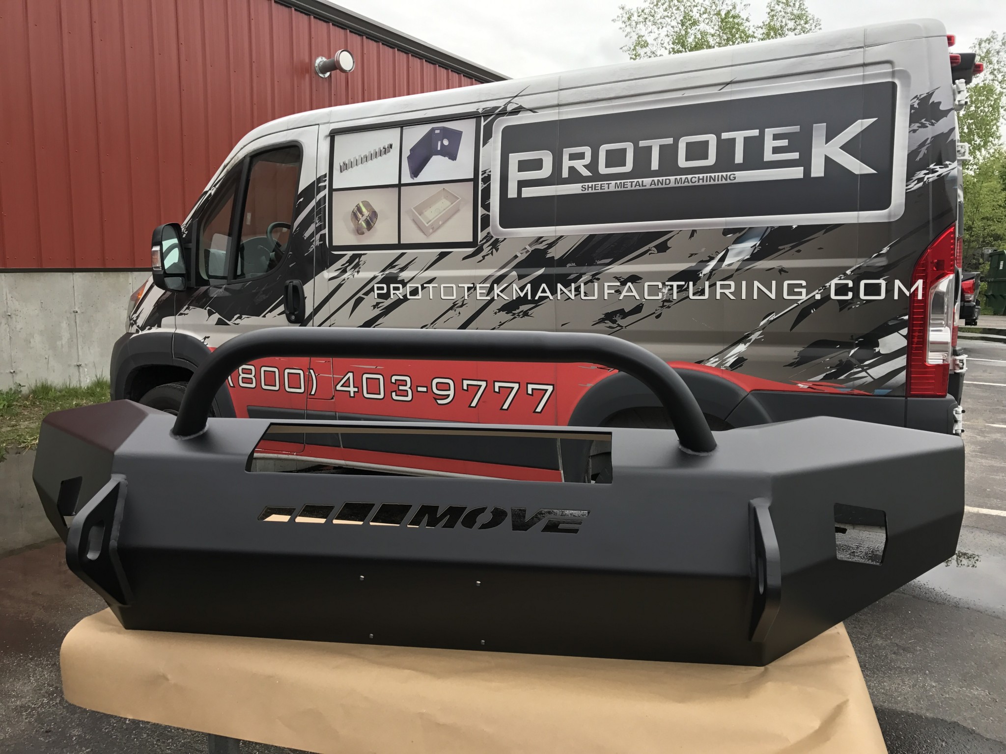 Prototyped part being displayed in front of a truck from Prototek.