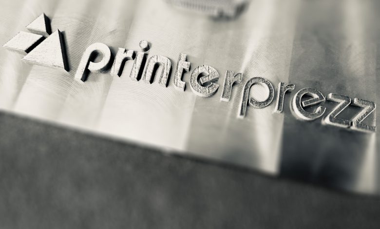 PrinterPrezz name engraved in 3D printed metal part.