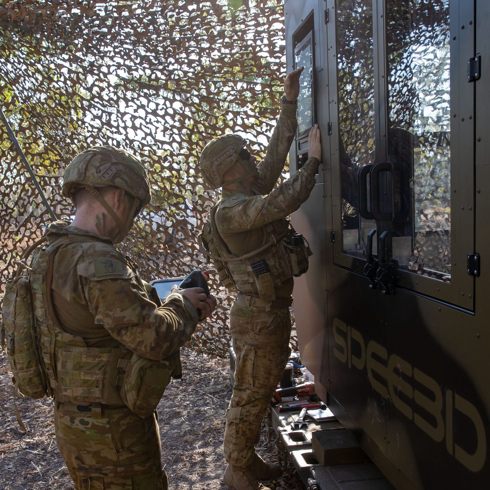 Australian Army soldier using SPEE3D printer to create parts on-site.