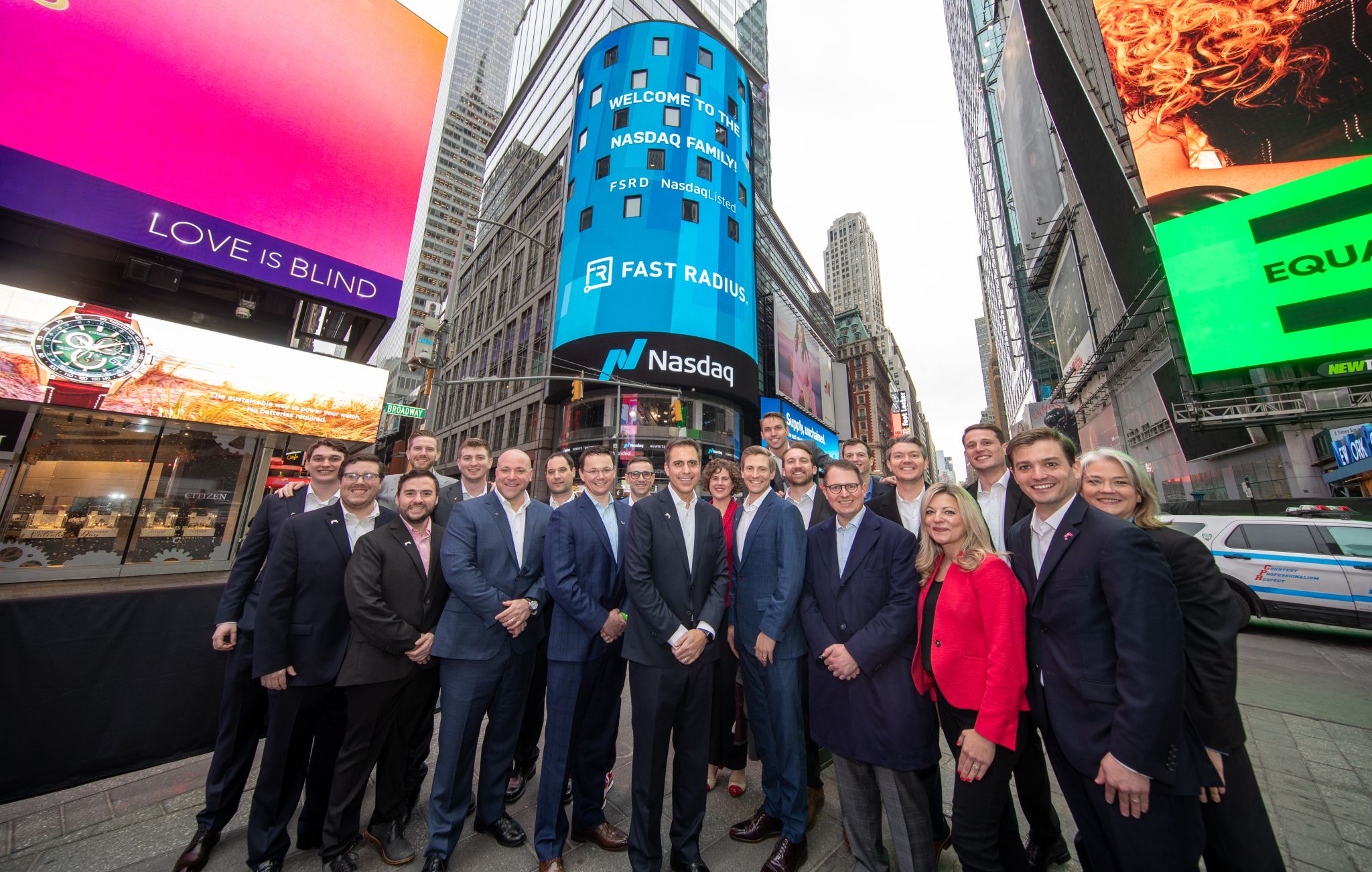 Fast Radius team takes photo outside Nasdaq during first trading day.