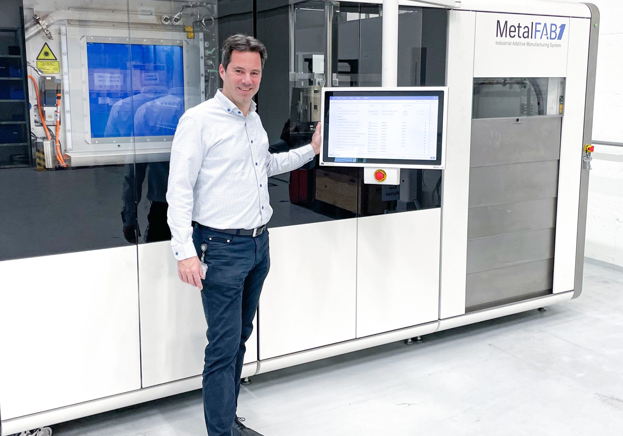 Egon Seegers, General Manager Service Parts of ABB Switzerland Ltd, Turbocharging next to the MetalFAB1 system. Image courtesy of Additive Industries. 