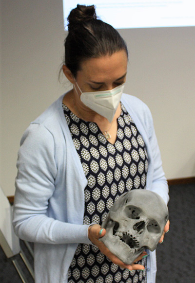 Professor Ericka L’Abbé holds a 3D print of a trauma skull from the Bakeng se Afrika trauma workshop. 