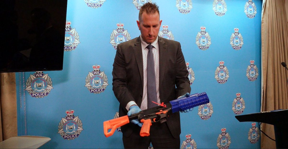 Australian detective with the 3D printed firearm seized from an 18-year old man. 