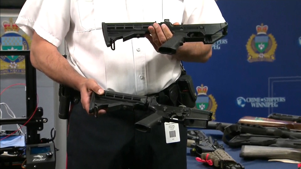 Winnipeg police show off two lower-end receivers for an AR-15. The one on the top was made with a 3D printer, the other is an example of a receiver that was commercially available.