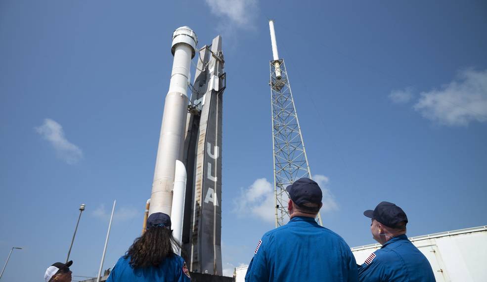 NASA astronauts watch as a United Launch Alliance Atlas V rocket with Boeing’s CST-100 Starliner spacecraft aboard is rolled out of the Vertical Integration Facility to the launch pad ahead of the Orbital Flight Test-2 mission at Cape Canaveral.