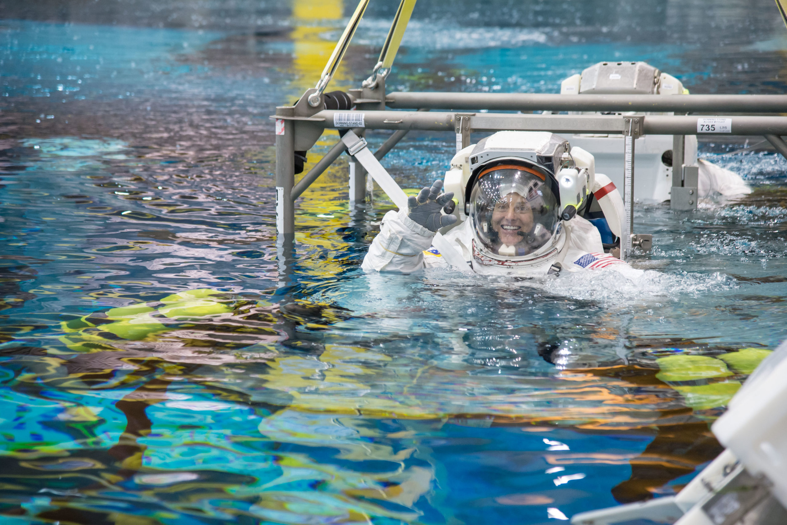 NASA astronaut Nicole Mann lowered into the Neutral Buoyancy Laboratory during a spacewalk training session. 